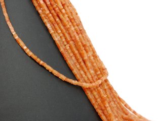 Orange-coloured, pierced calcite discs