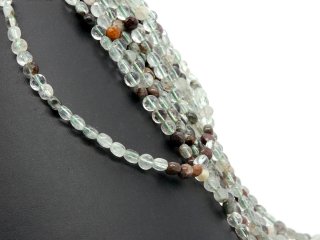 Pierced, green and brown fluorite discs with facets
