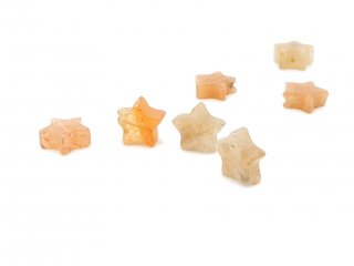 Four pierced orange calcite stars