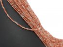 Faceted, pierced and orange-coloured sunstones