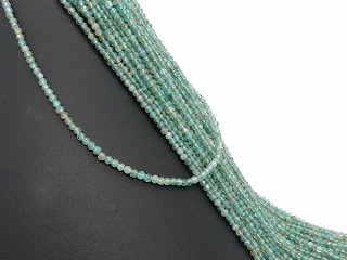 Small, drilled quartz spheres with facets in green