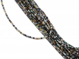 Mixed, colourful, pierced gemstones with facets