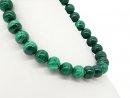 Pierced green malachite spheres