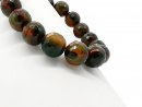 Green-red, faceted, pierced agate spheres