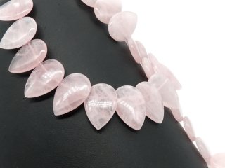Pierced, teardrop-shaped rose quartz discs