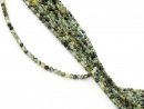 Small, drilled quartz spheres with facets in green