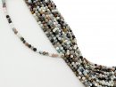 Mixed, colourful, pierced gemstones with facets