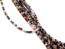 Mixed, colourful, pierced gemstones with facets