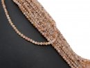 Small, pink-coloured, pierced quartz beads with facets