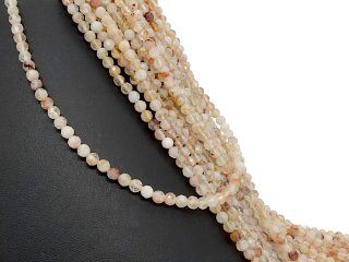 Petites boules de quartz percées à facettes dans les tons pêche