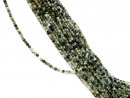 Small, drilled quartz spheres with facets in green