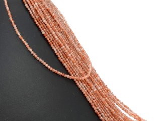 Facettierte, durchbohrte und orangefarbene Sonnensteine