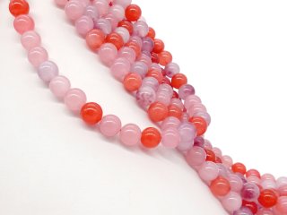 Rote und rosafarbene, durchbohrte Quarzitkugeln