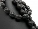 Perforated black lava stones for jewellery