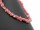 Pierced, pink-coloured rhodochrosite gemstone chips