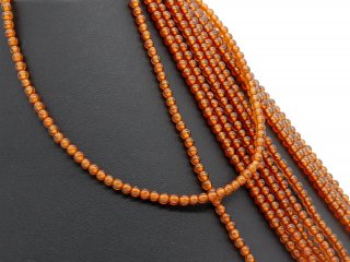Orange-coloured, pierced garnet beads