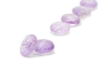 Two faceted, pierced amethyst discs
