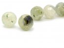 Two faceted garnet beads in green