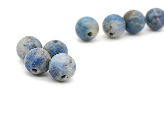 Four matt, blue-grey lapis spheres
