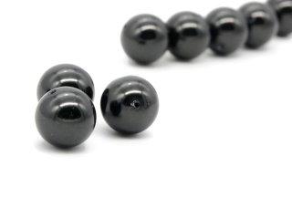 Three black shell pearls