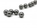 Five dark grey pierced shell pearls