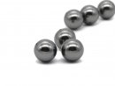Three dark grey pierced shell pearls