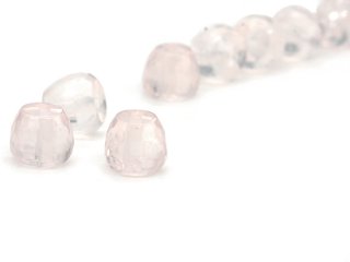 Three faceted, pierced rose quartz crystals