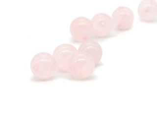 Four pierced rose quartz balls