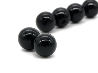 Two black pierced tourmaline beads