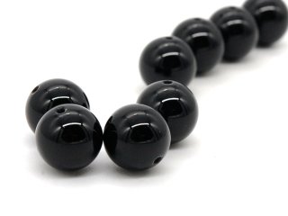 Four black pierced onyx balls