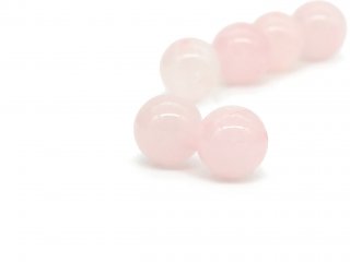 Two pierced rose quartz balls