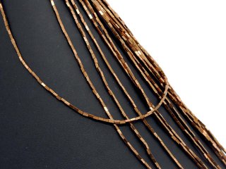 Pierced, rectangular haematite rollers in brown