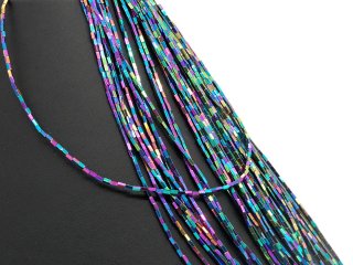 Colourful iridescent, pierced hematite in grey