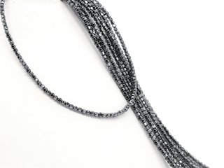 Shiny, pierced spheres made of hematite in grey