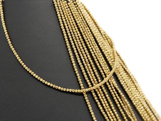 Pierced, sparkling, golden haematite spheres